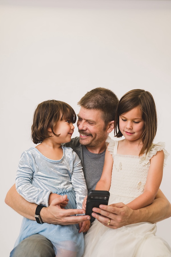 Father and daughters enjoying story time together